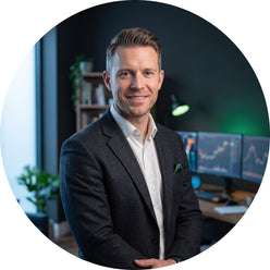 Portrait of Julian Vance, a professional trader, posing in a modern office setting with a dark, sophisticated aesthetic.