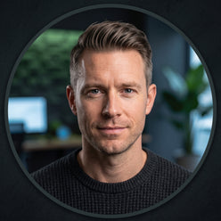 Professional headshot of trader David Stein against a blurred, dark office background with subtle green and blue lighting.